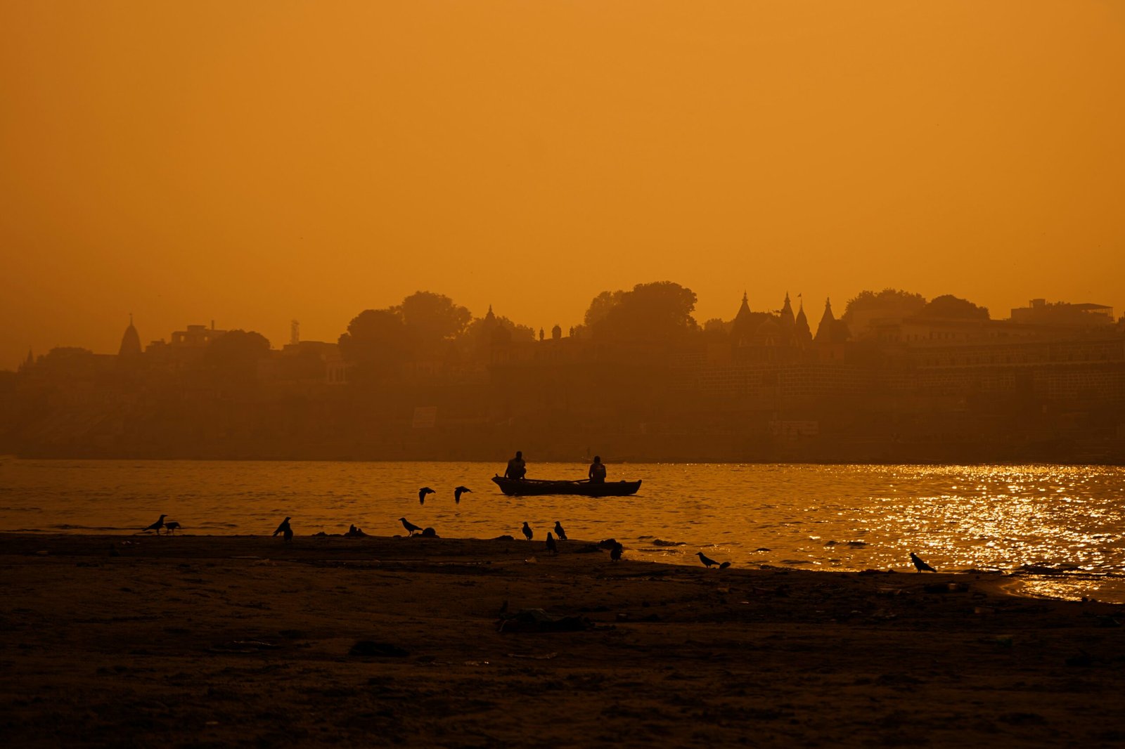 Evening river ritual with floating lamps on the Ganges