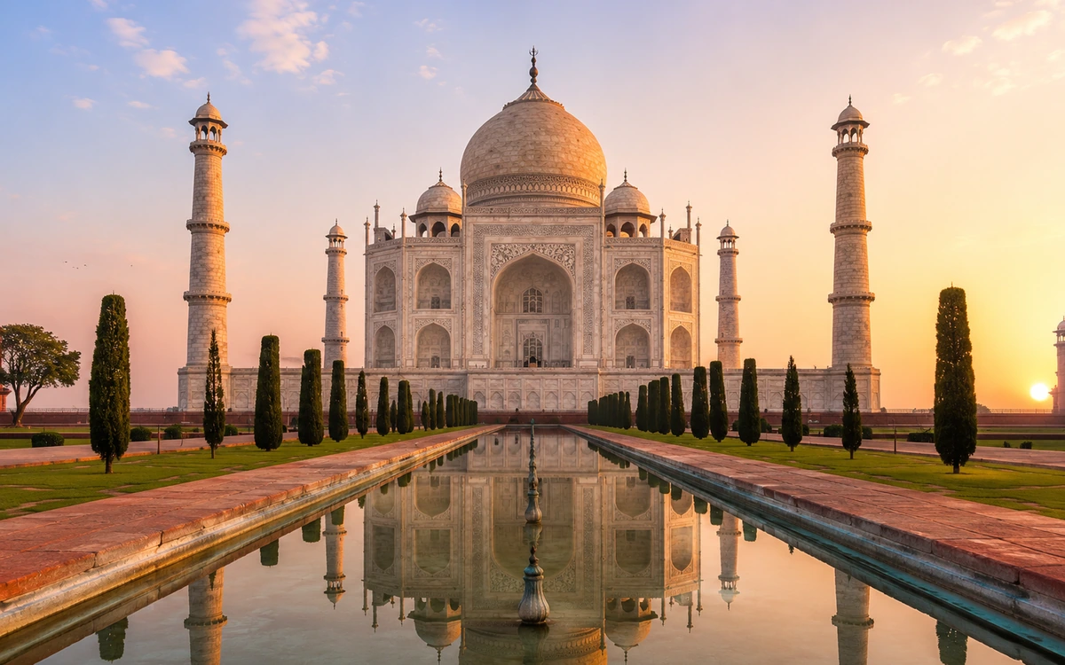 The Taj Mahal at sunrise reflected in its pool, Agra, Uttar Pradesh