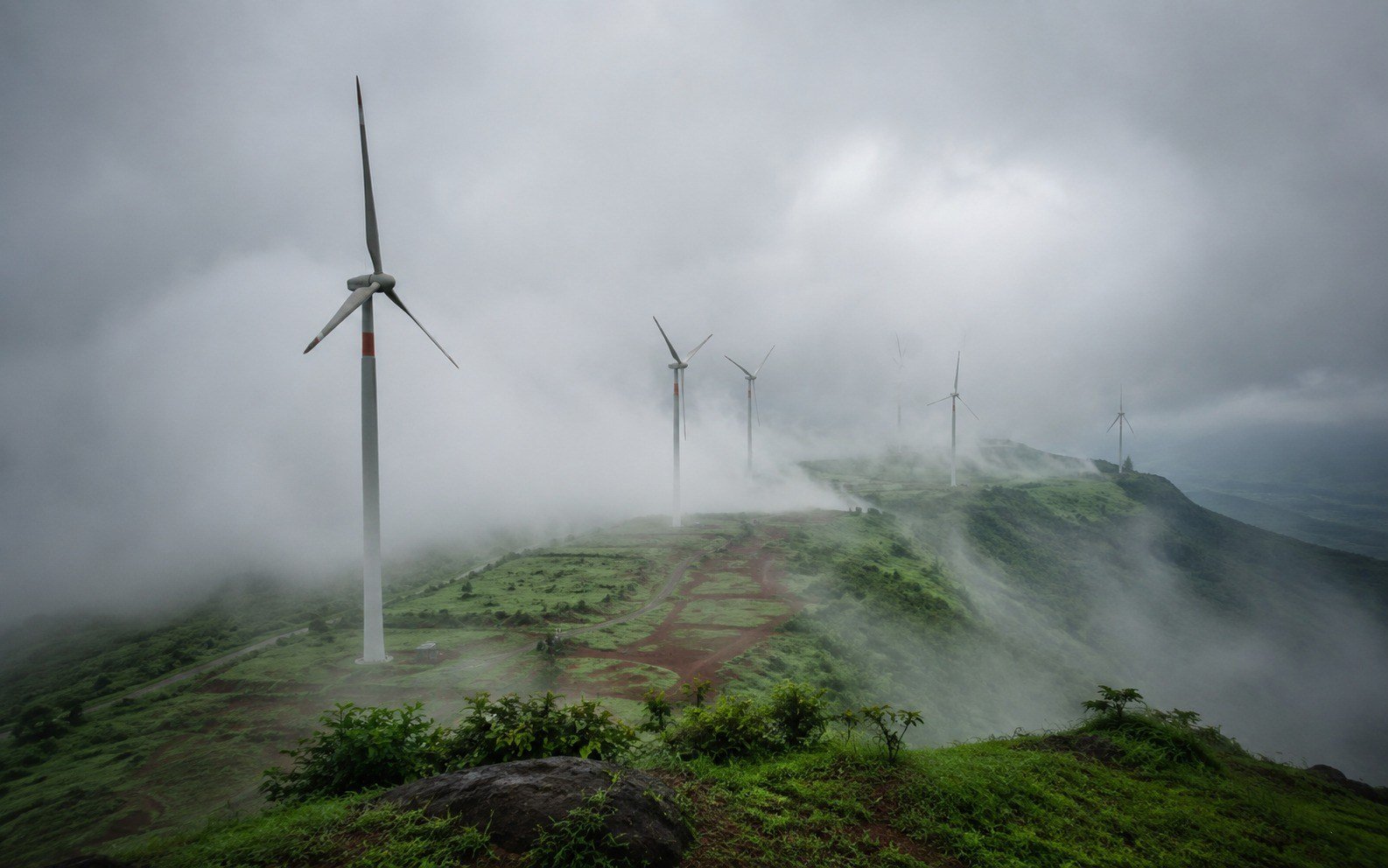 Wind turbines shrouded in monsoon mist on the Chalkewadi plateau near Satara