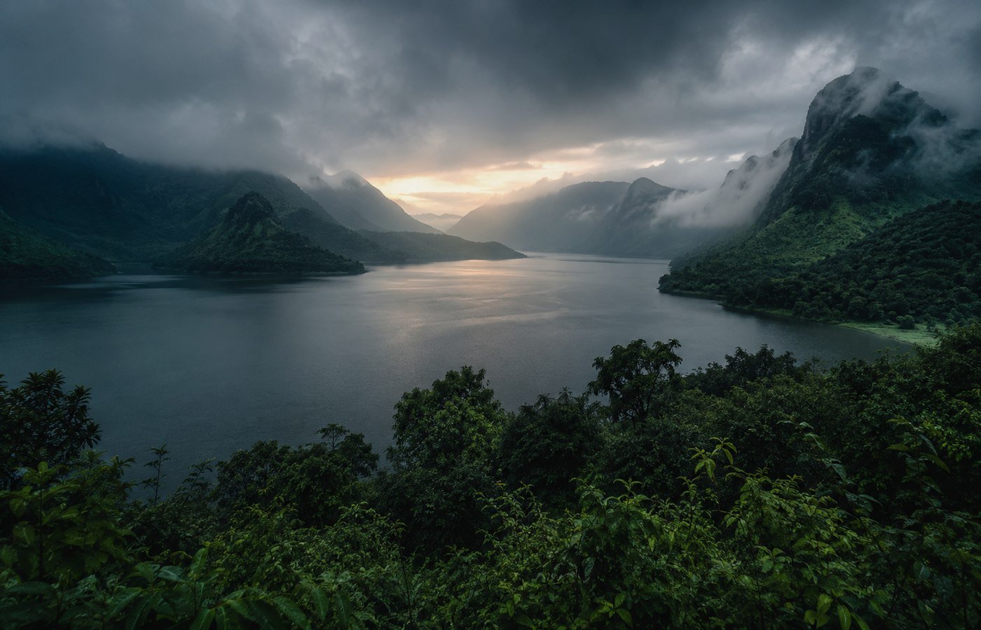 Mist rising over Arthur Lake at dawn near a quiet lakeside camp in Bhandardara