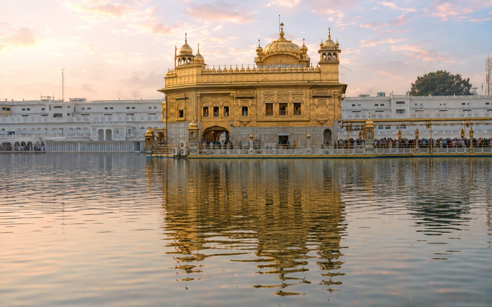 The Golden Temple (Harmandir Sahib) reflected in its sacred pool at dawn, Amritsar
