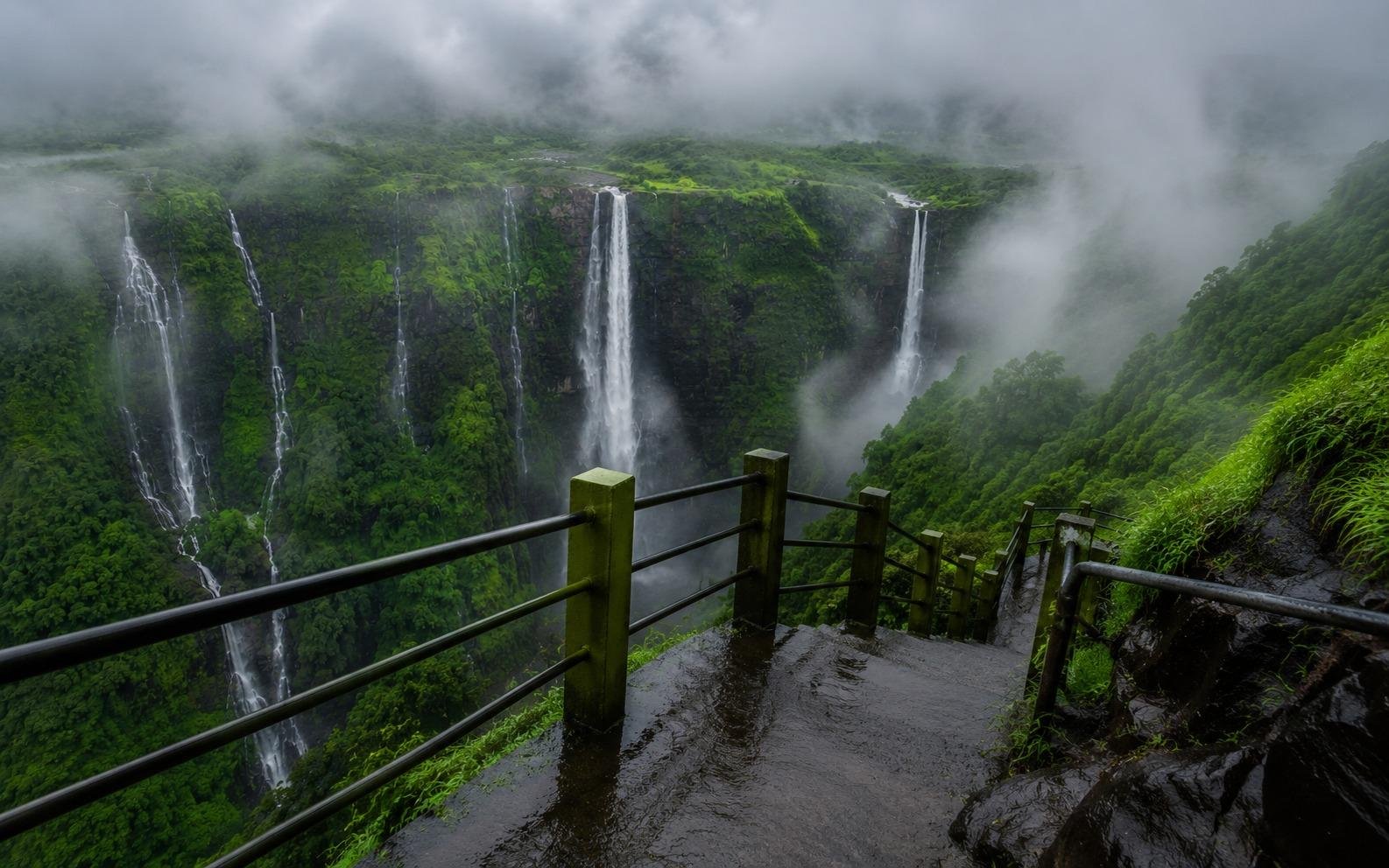 Viewing platform looking out over misty Thoseghar waterfalls in monsoon