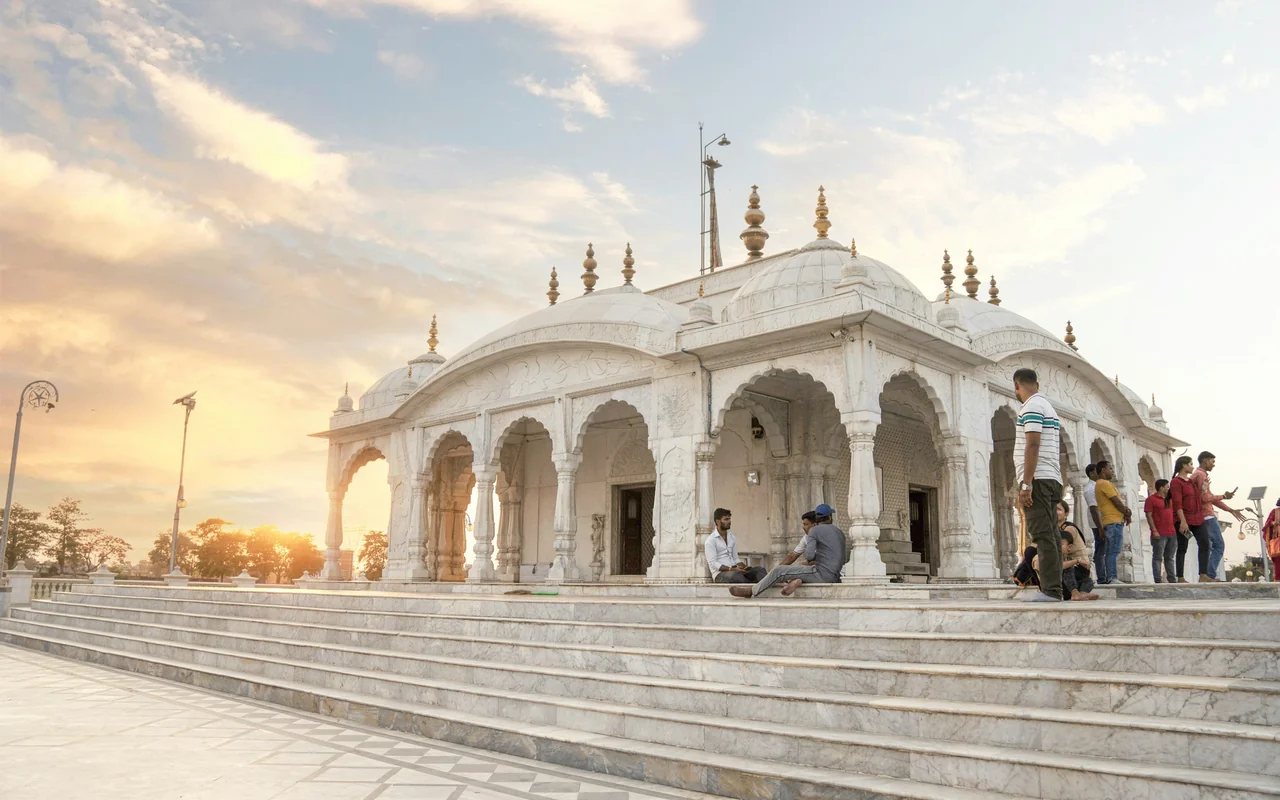The white marble Jal Mandir water temple at Pawapuri reflected in its lotus tank at sunset, Bihar