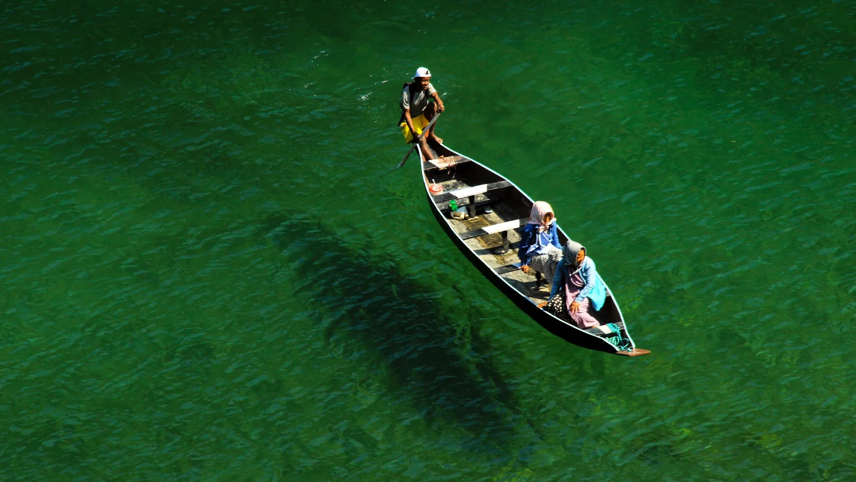A boat casting its shadow on the riverbed through the clear Umngot river at Dawki, Meghalaya