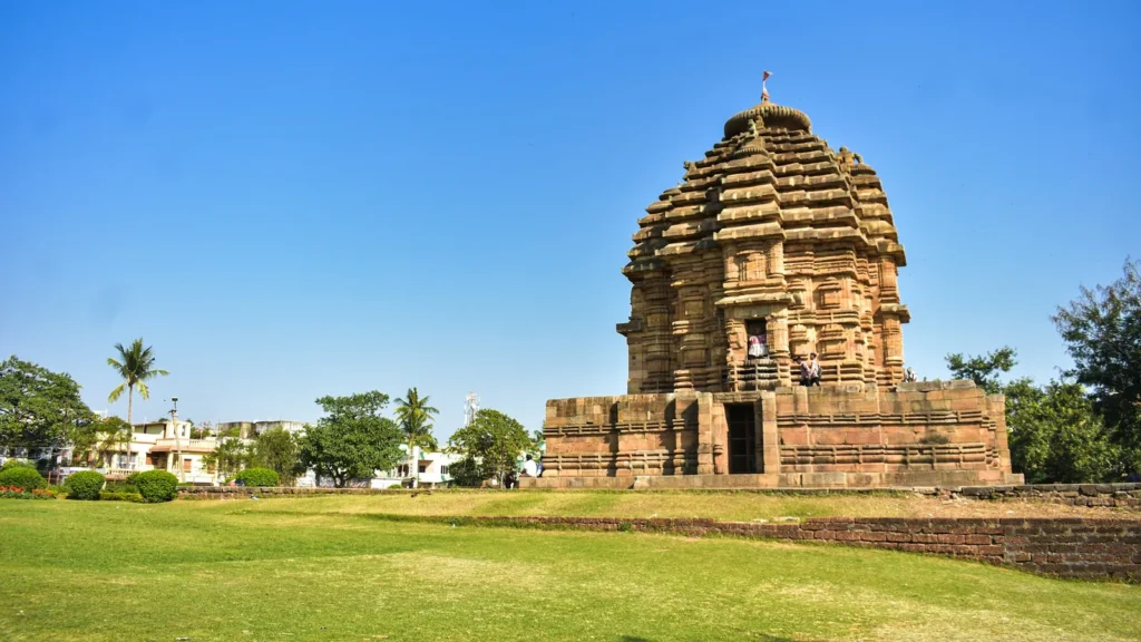 A Kalinga-style stone temple on a green lawn in Bhubaneswar, Odisha