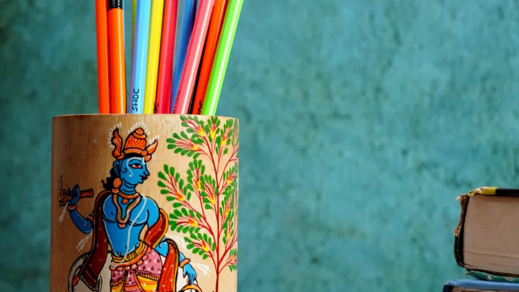 A pattachitra-painted holder with a Krishna motif, a traditional Odisha craft from Raghurajpur