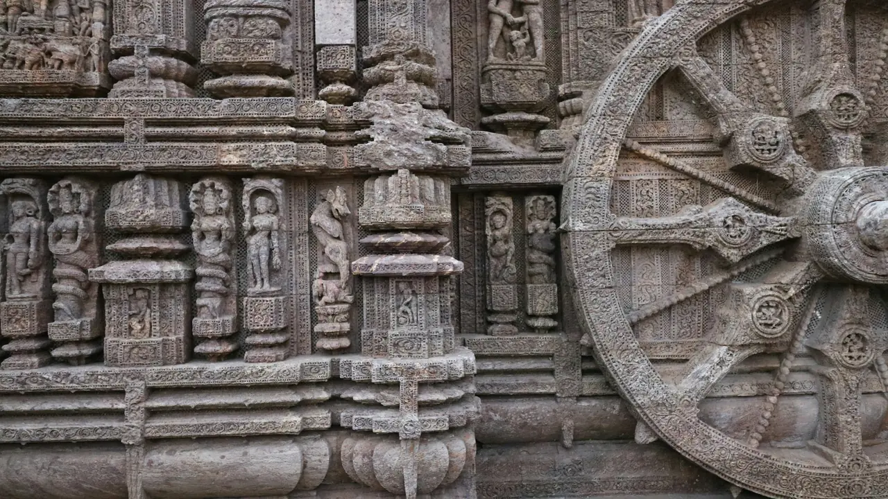 A large carved stone chariot wheel on the base of the Konark Sun Temple